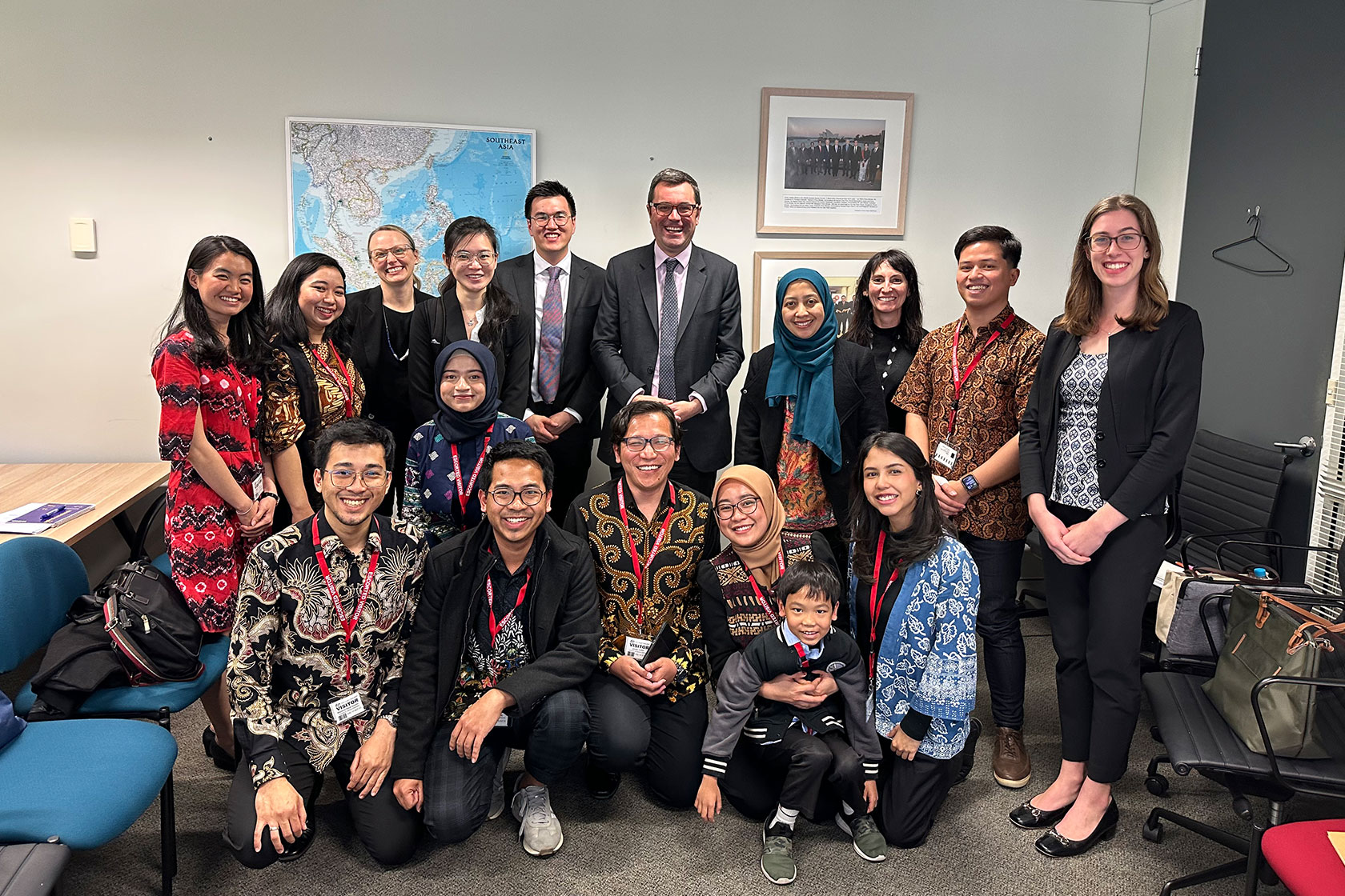The scholars capture a group photograph alongside DFAT representatives as part of their visit to the DFAT office.