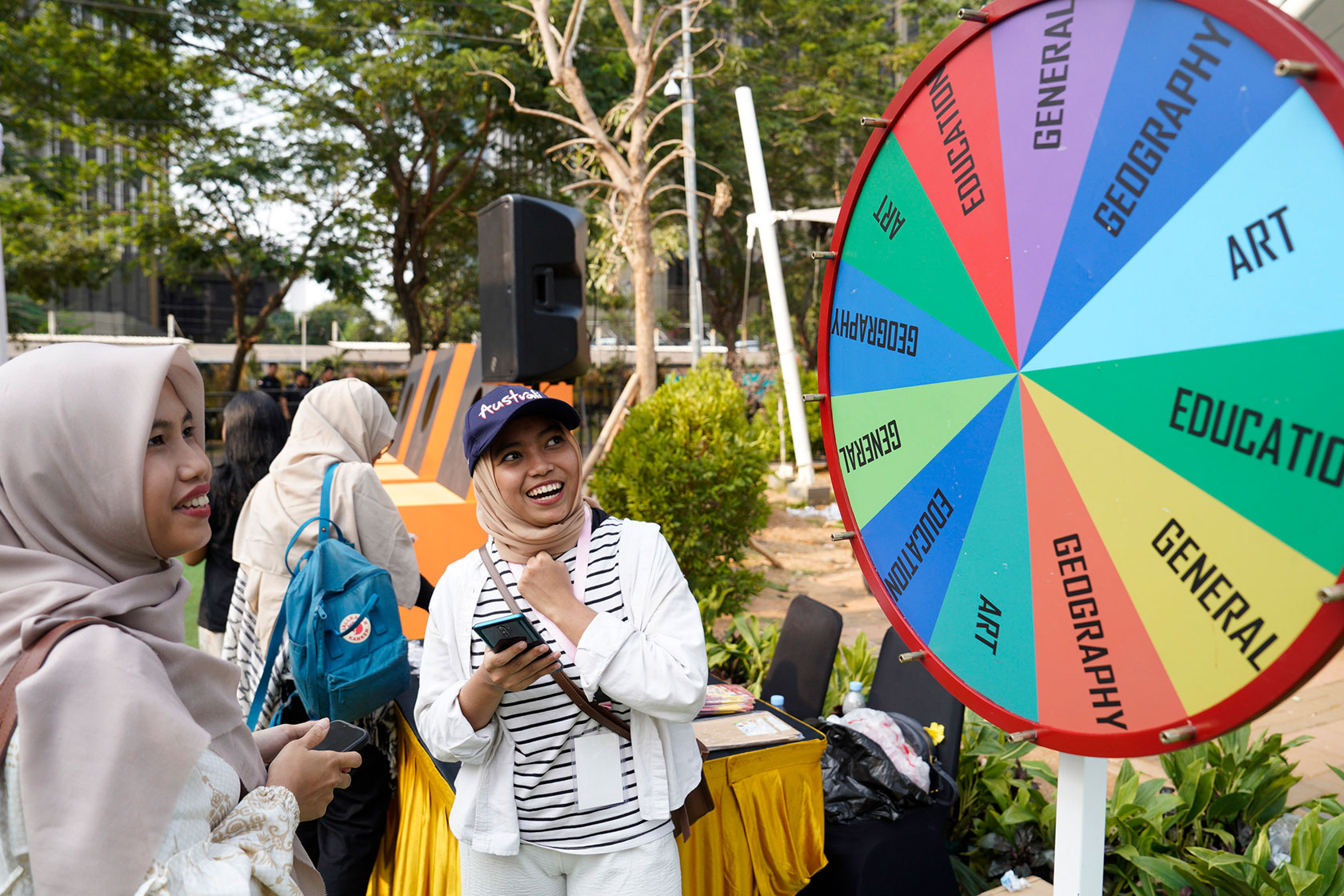Alumni engage in enjoyable activities, including a lively game of Wheel of Fortunes.
