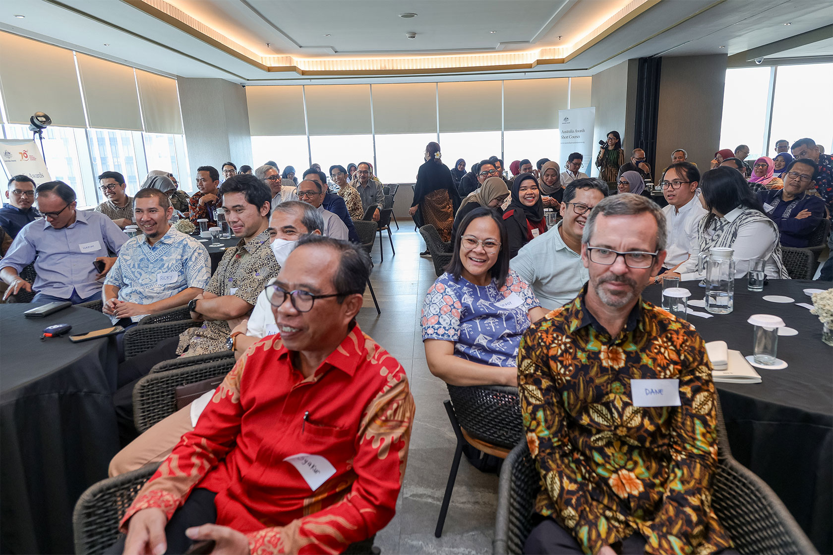 Participants delight in the enriching exchange of knowledge as they engage with speakers' insights at the luncheon.