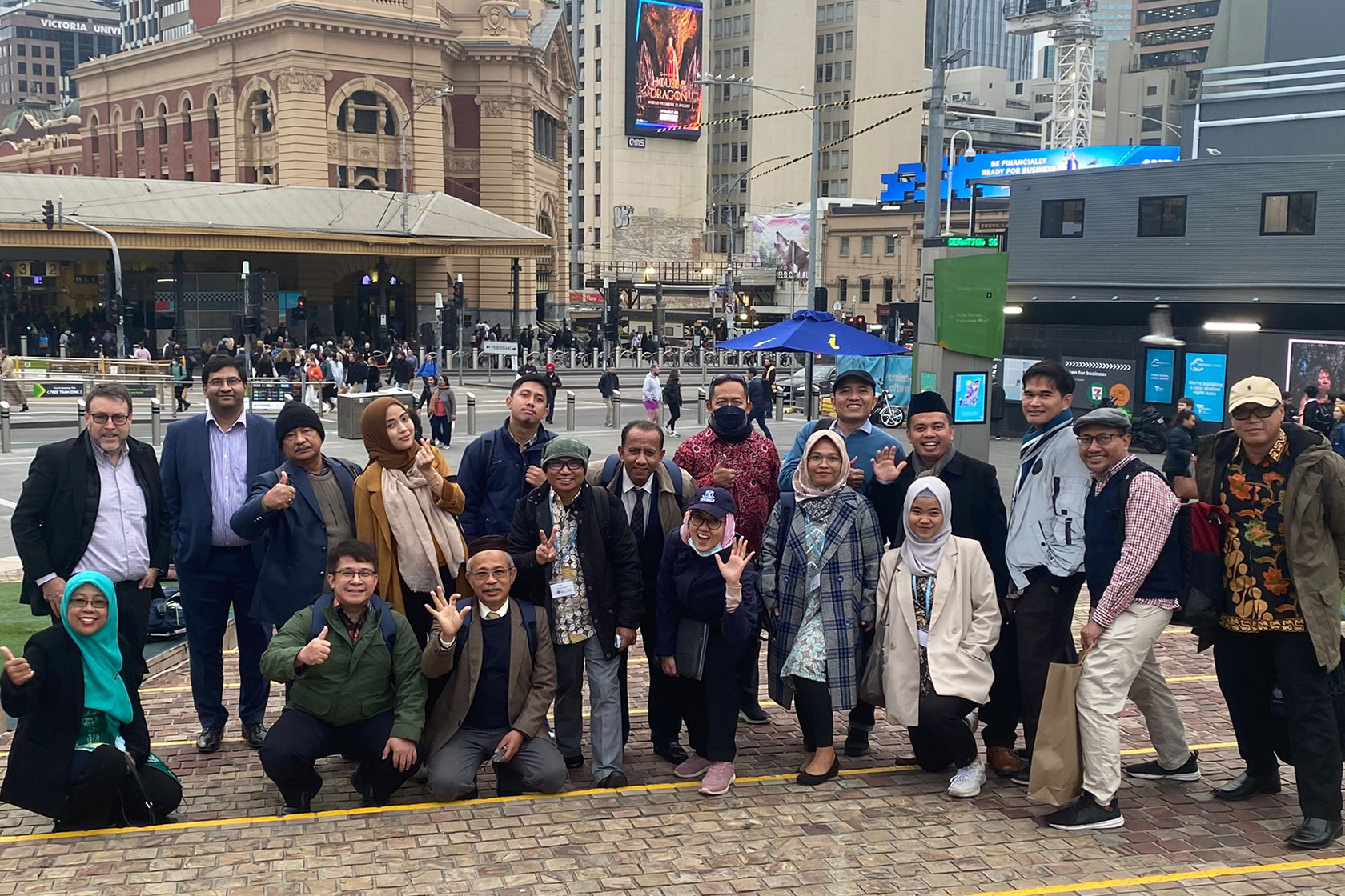 A group photo of participants with the famous Flinders Station in the background