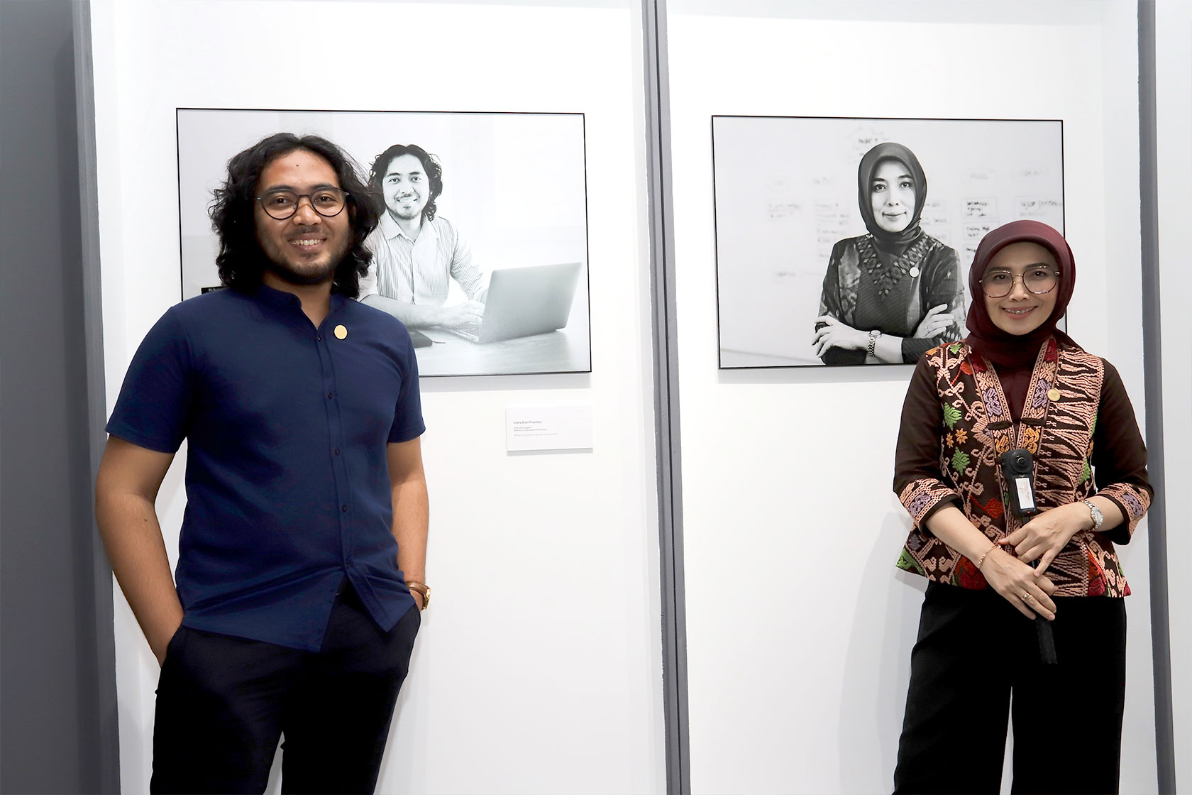Notable Alumni Indra Dwi Prasetyo and Rahayu Puspasari pose with pride in front of their photos.