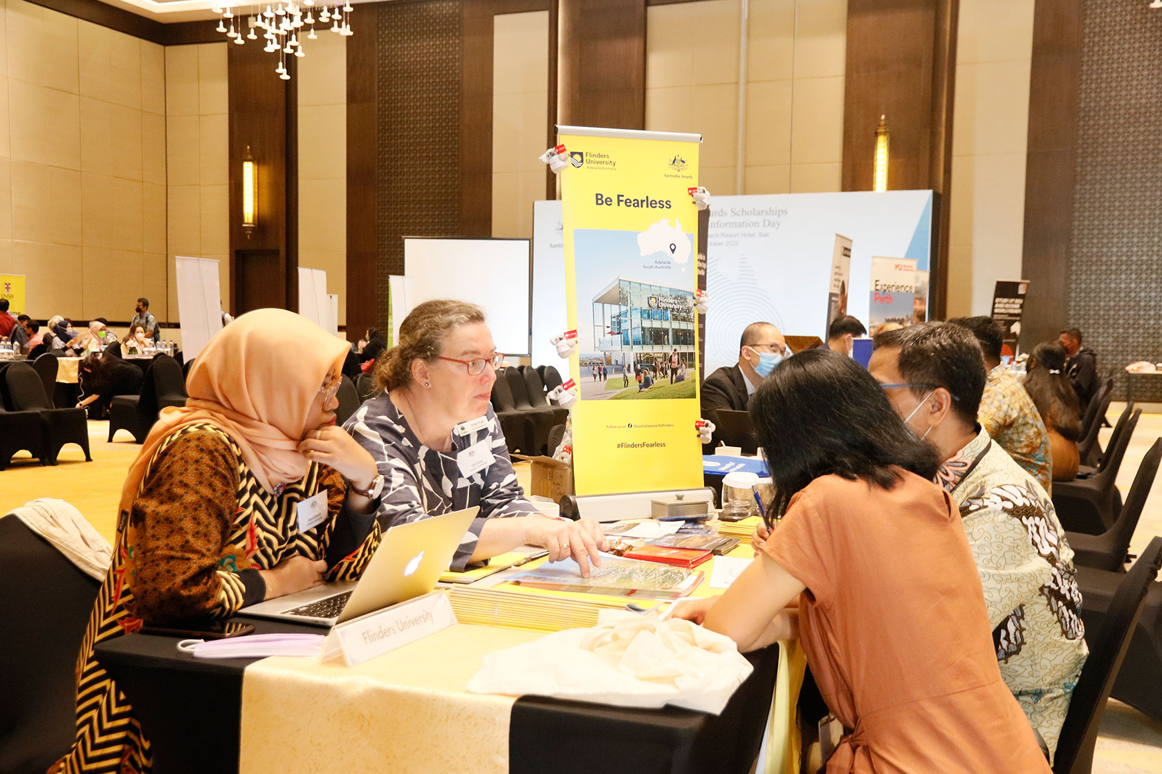 A picture of two Australia Awards scholars sitting down and consulting with two representatives from Flinders University