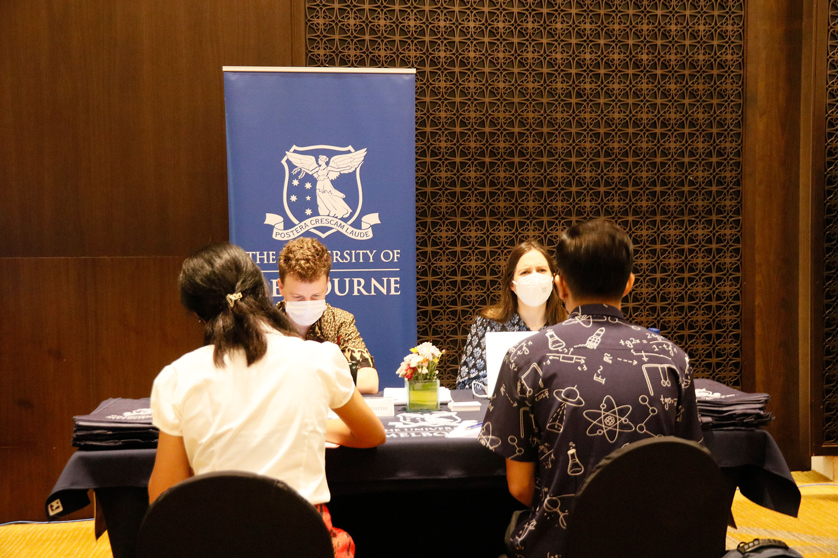 A picture of two Australia Awards scholars sitting down and consulting with two representatives from the University of Melbourne 