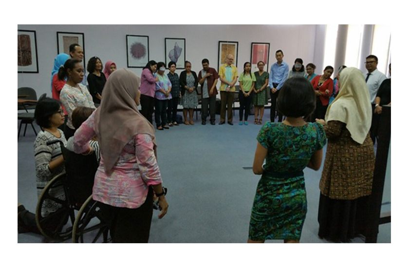 a group of people are standing in circle