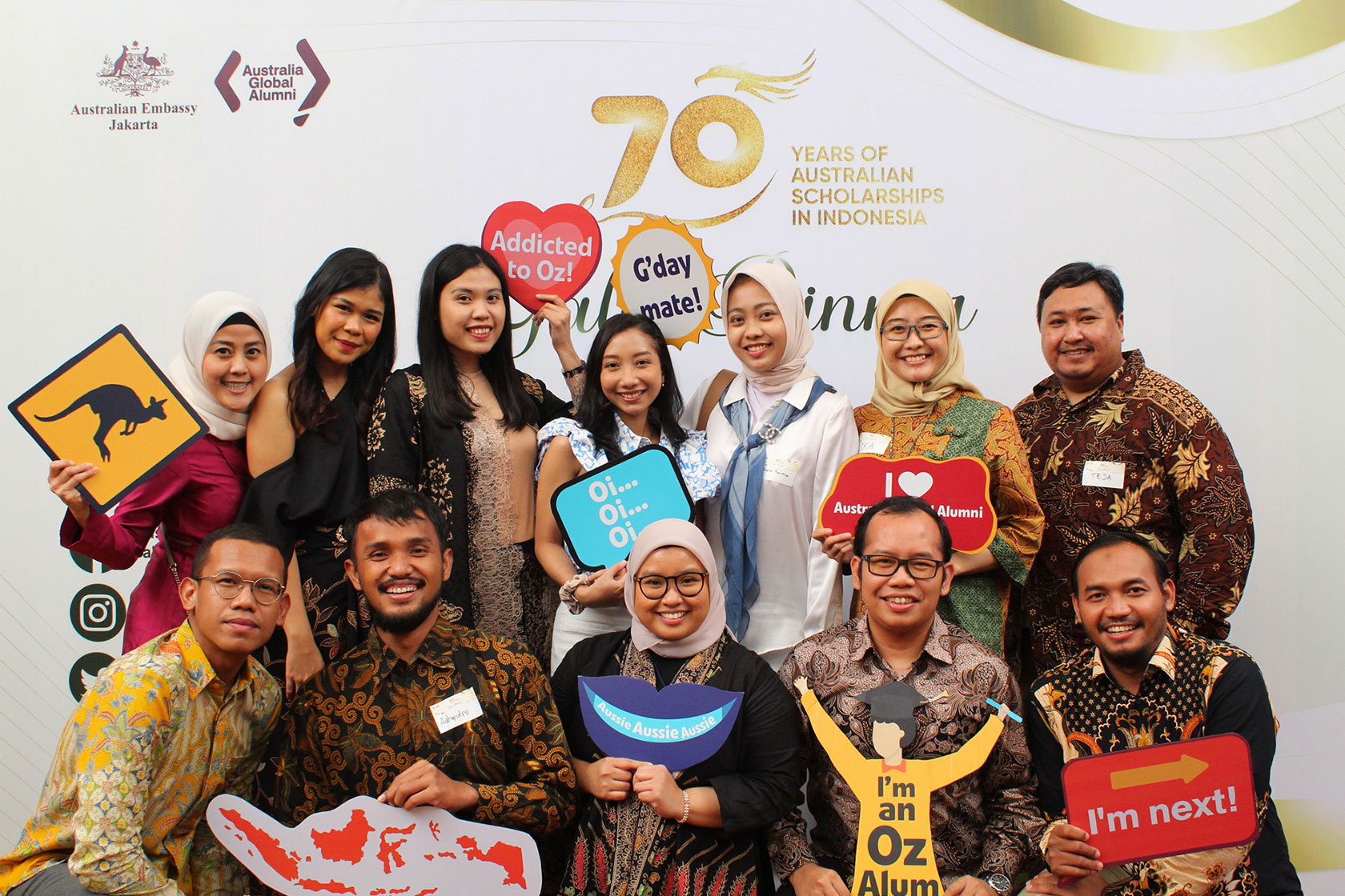 A group of Australian alumni cherish memories at the photo booth.