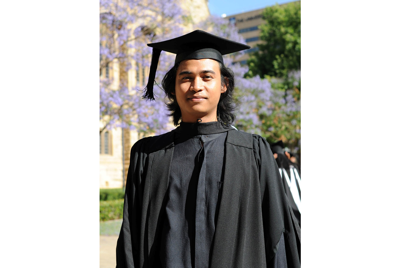 A picture of Ahmad Junaidi, an Australia Awards alumnus, wearing a graduation robe